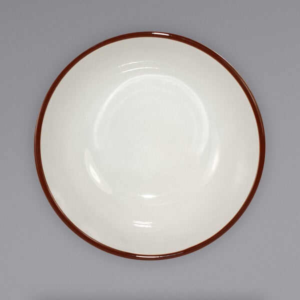 A white bowl with a narrow brown speckled rim.