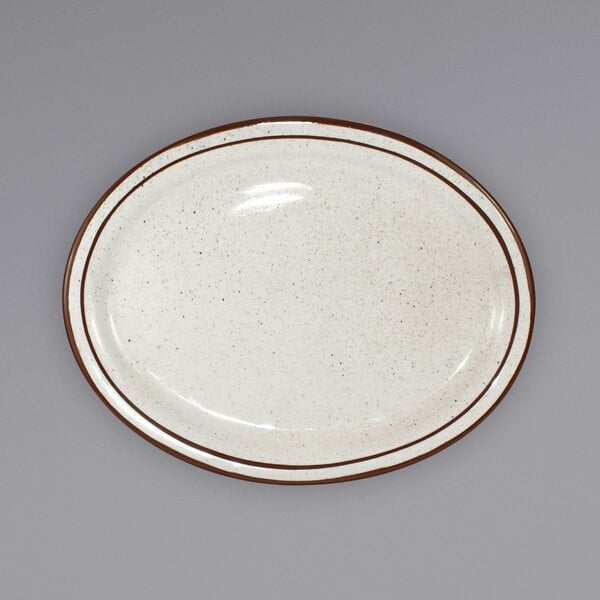 An International Tableware ivory stoneware platter with brown speckled edges.