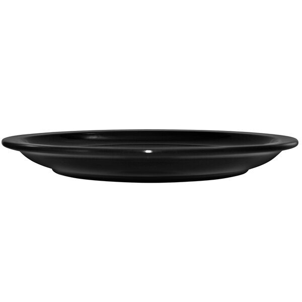A black International Tableware stoneware plate with a rolled edge on a white background.