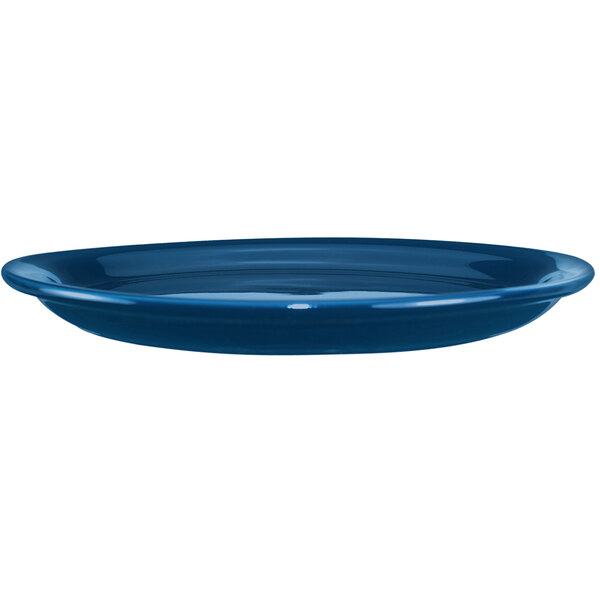 A light blue International Tableware stoneware platter with a narrow rim.
