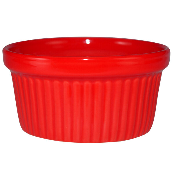 A crimson red fluted stoneware ramekin.