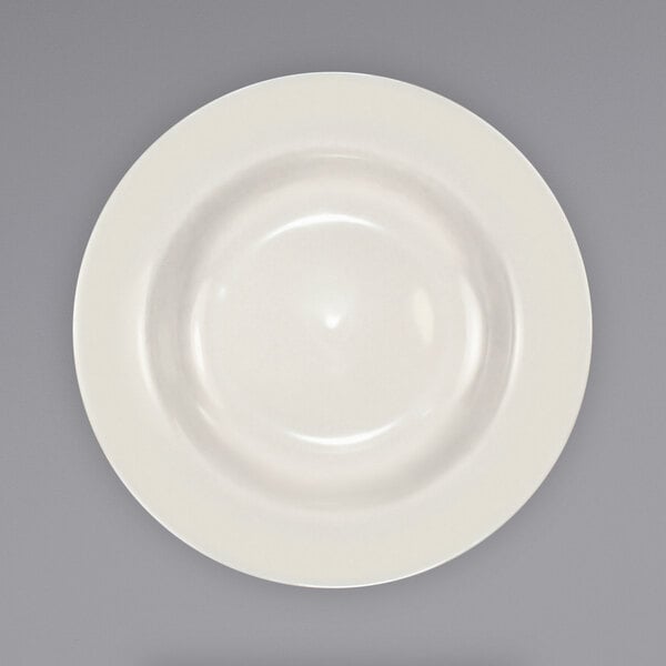 A close-up of an International Tableware Roma stoneware deep rim soup bowl with a white center and rim.