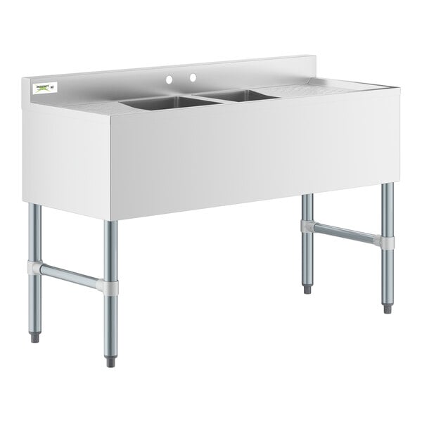 A stainless steel Regency underbar sink with two drainboards and two sinks on a counter.