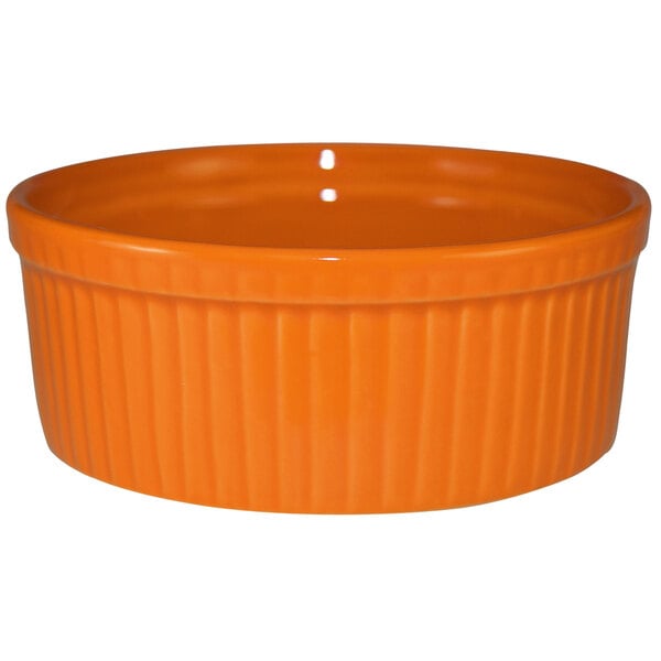 An orange International Tableware stoneware fluted ramekin.