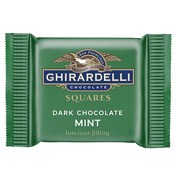 A close-up package of Ghirardelli dark chocolate mint squares.