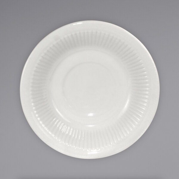 An International Tableware ivory stoneware saucer with an embossed pattern.