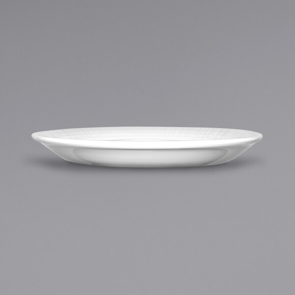 A white saucer with a rim on a gray background.