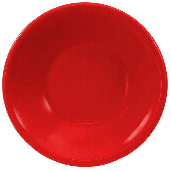 A close-up of a red bowl with a white background.
