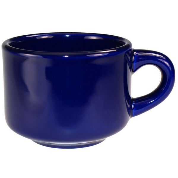 A cobalt blue stoneware coffee cup with a handle.