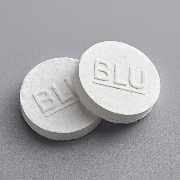 A stack of white round Mercer Culinary BLU compressed towels with the word "blu" on them.