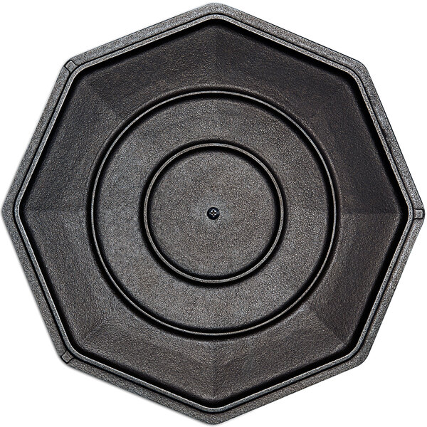 A black octagonal cast iron cover with a circular center.