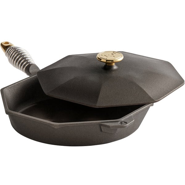 A pre-seasoned black cast iron FINEX skillet with a lid and handle.