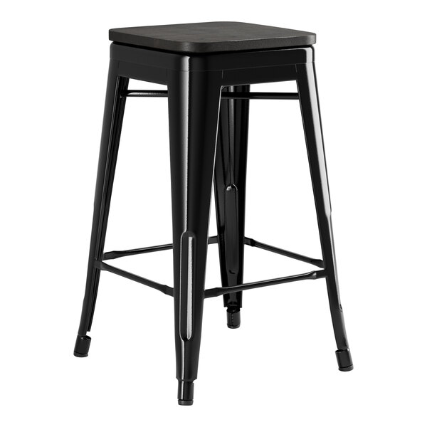 A Lancaster Table & Seating black metal backless counter height stool with a black wood seat.