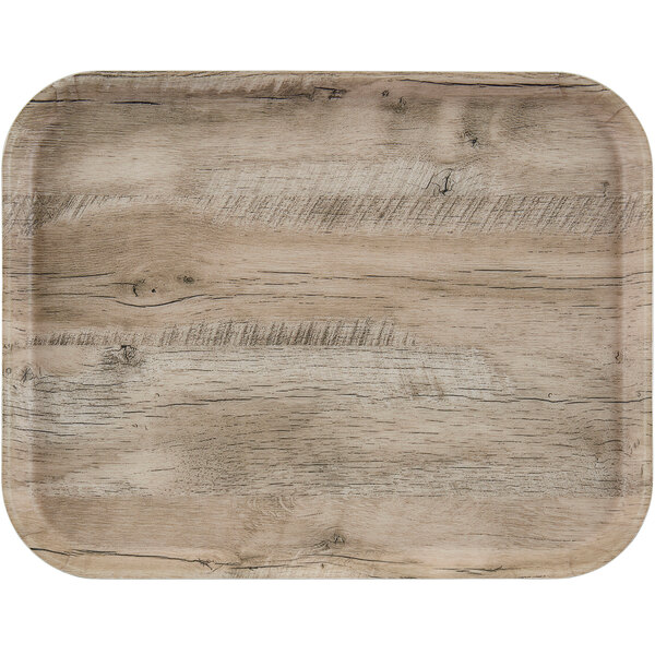 A light olive Cambro EpicTread fiberglass tray with a non-skid surface on a wood table.