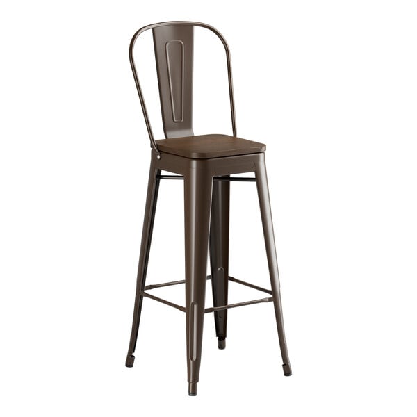 A brown metal Lancaster Table & Seating bar stool with a walnut seat.