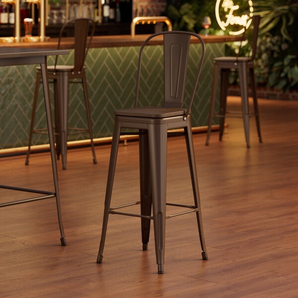 A Lancaster Table & Seating copper barstool with a wood seat and backrest.