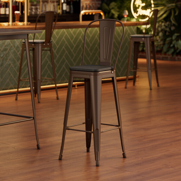 A Lancaster Table & Seating copper barstool with a black wood seat.