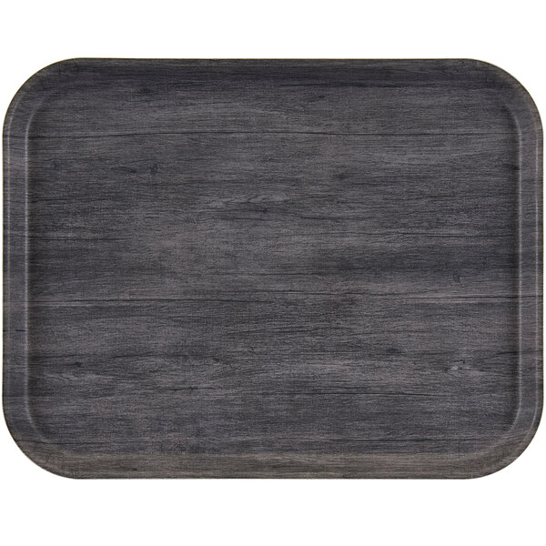 A charcoal gray rectangular Cambro tray with non-skid surface on a table.