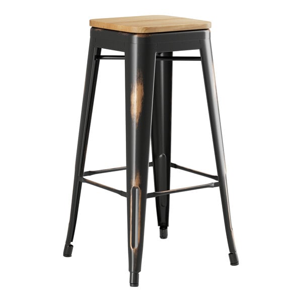 A Lancaster Table & Seating black metal barstool with a natural wood seat.