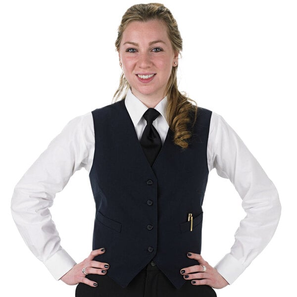A woman in a navy blue Henry Segal server vest and tie.