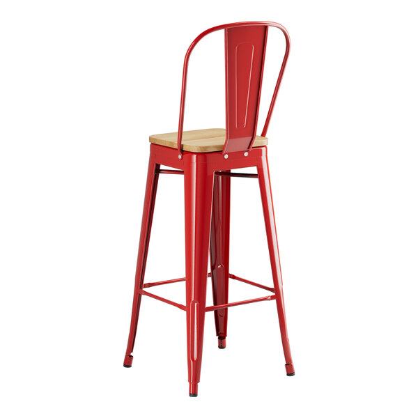 A Lancaster Table & Seating red metal barstool with a natural wood seat.