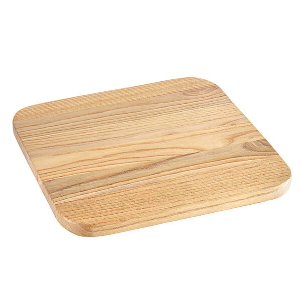 A Lancaster Table & Seating backless barstool with a natural wood seat at a table with a wooden square cutting board.