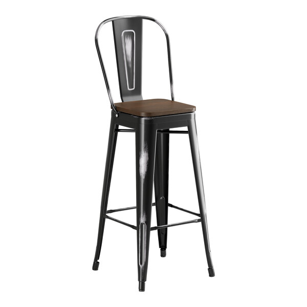 A Lancaster Table & Seating black metal barstool with a walnut wood seat.