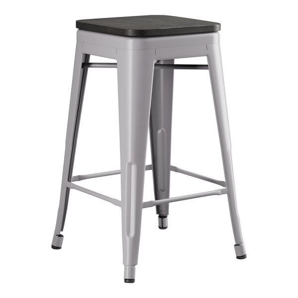 A Lancaster Table & Seating nickel gray metal backless counter height stool with a black seat.