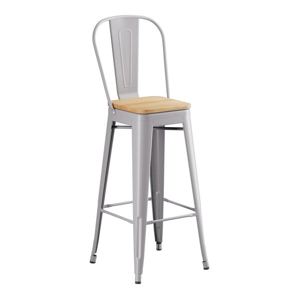A Lancaster Table & Seating metal barstool with a natural wood seat.