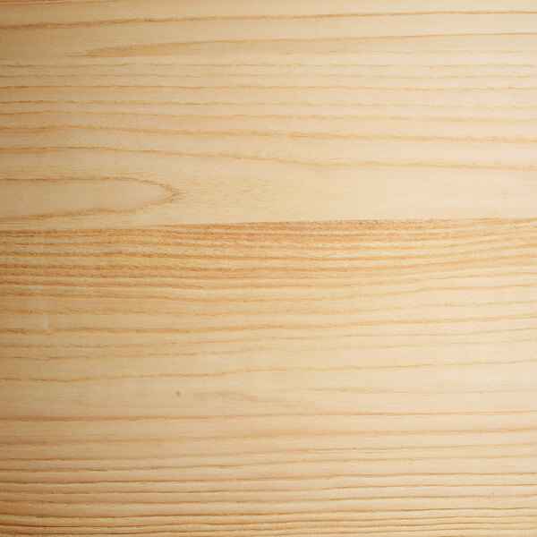 A close up of a natural wood surface with a wood grain.