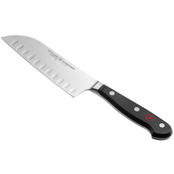 A Wusthof Classic Santoku knife with a black handle.