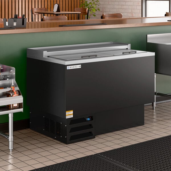 A black commercial glass froster and plate chiller with sliding lids, designed for bar or restaurant use.