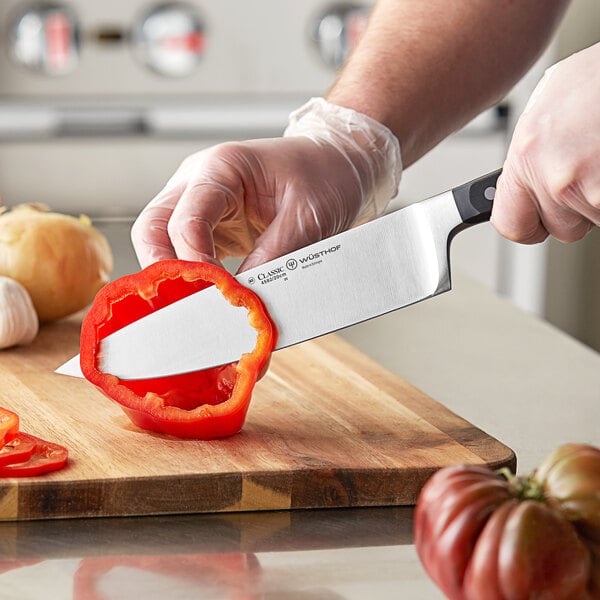 Chef cutting peppers with a Wusthof chef's knife