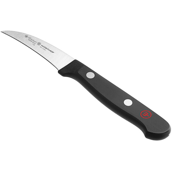 A Wusthof peeling knife with a black handle.