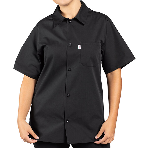 A woman wearing a black Uncommon Chef short sleeve cook shirt.