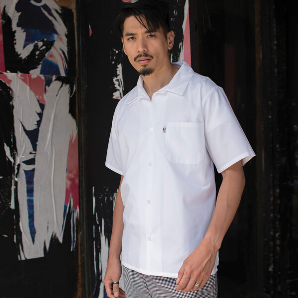 A man wearing a Uncommon Chef white cook shirt.