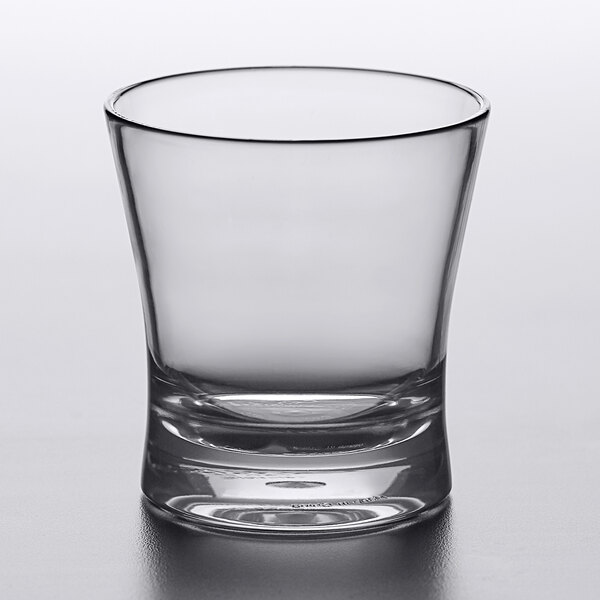 A clear Carlisle Alibi rocks glass on a white surface.