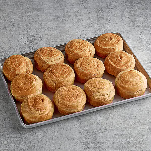 A tray of Upper Crust all butter round croissant buns.