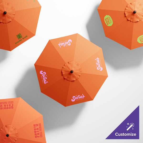 A customized California Umbrella with an orange Sunbrella canopy and white text.