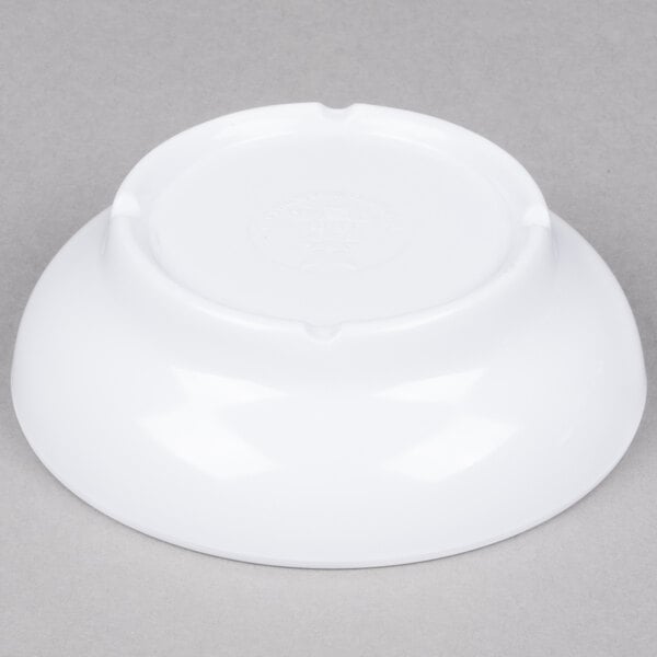 A white bowl on a gray surface.