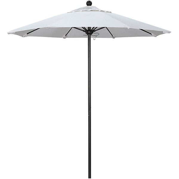 A white California Umbrella on a black pole.