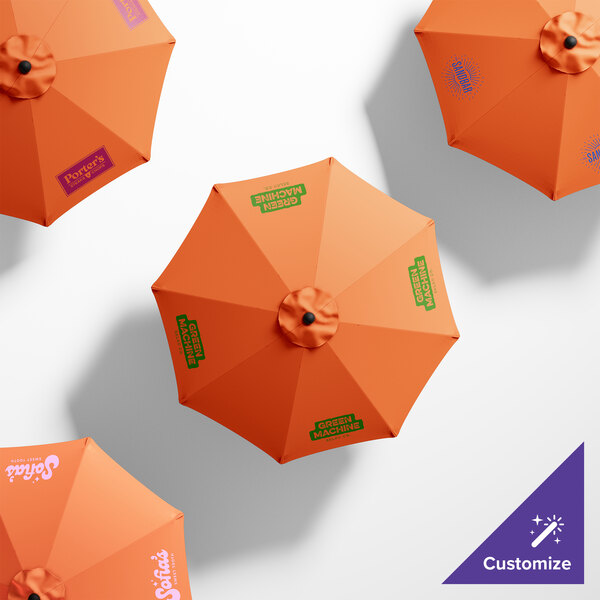 A customizable California Umbrella with an orange Sunbrella canopy and white, green, and blue text on it.