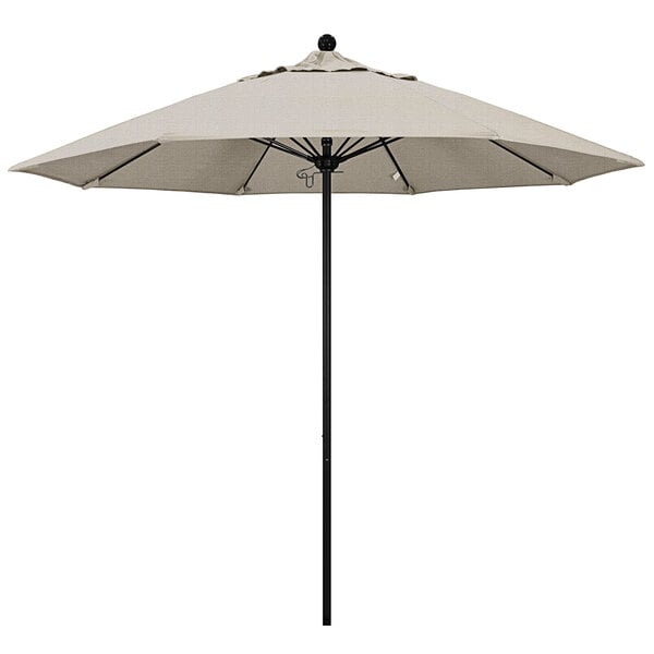 A white California Umbrella on a black pole.