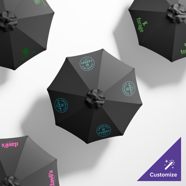 A group of black California Umbrellas with custom green writing on the canopies.