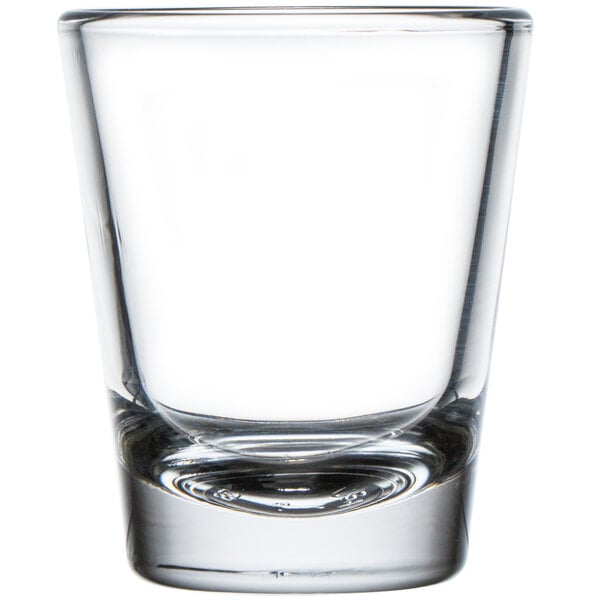A clear Libbey shot glass with a white background.