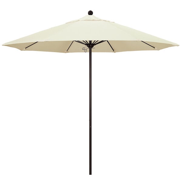 A white California Umbrella on a black pole.
