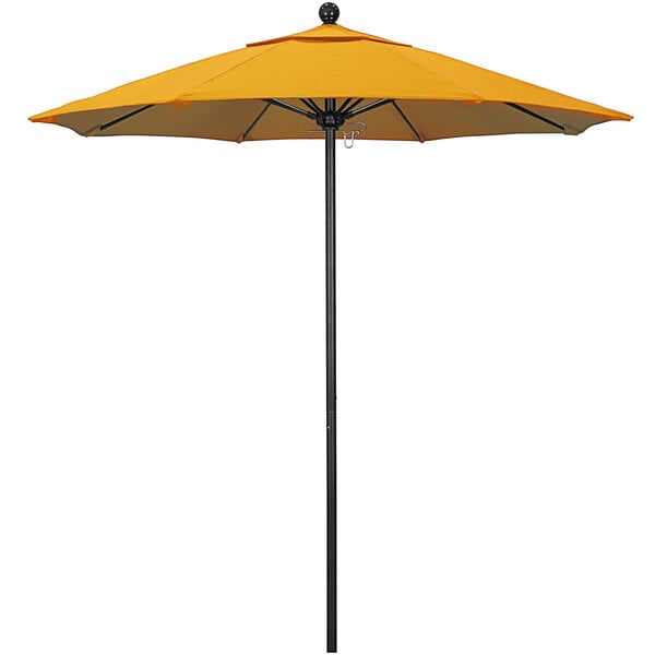 A yellow California Umbrella on a black pole.