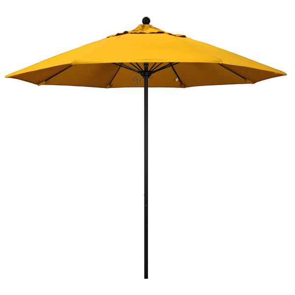 A yellow California Umbrella on a black pole.