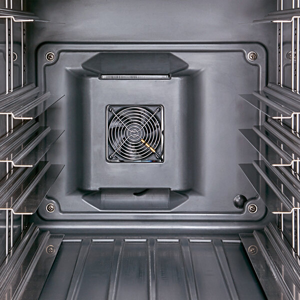The interior of a Cambro Pro Cart Ultra in black with metal shelves and a fan.