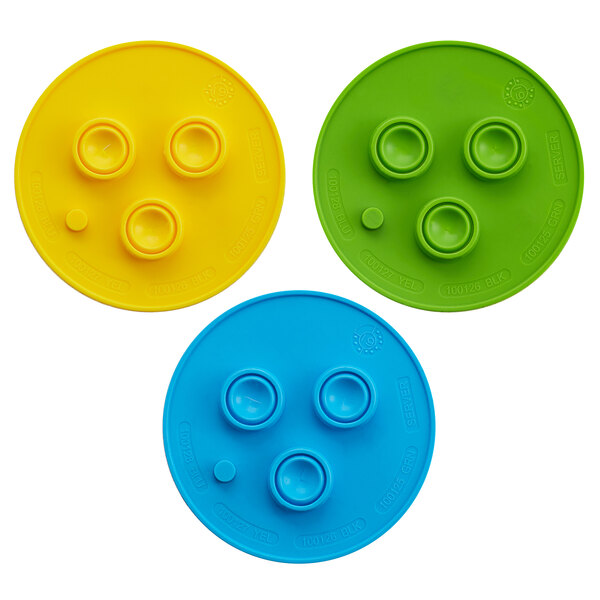 A Server ProPortion Handheld Triple-Tip Dispenser with three circular plastic plates. The first plate is yellow with four holes, the second is blue with four holes, and the third is green with four circles.